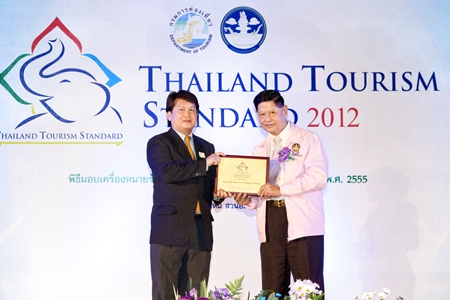 Chumpol Silapa-archa (right), Minister of Tourism and Sports presents the 2012 Thailand Tourism Standard Award to Kulasate Howongratana, director of the Kasemkij Hotels Group. The group received the award recently for their outstanding long stay properties, namely the Cape Racha Hotel Sriracha and the Kameo House, Rayong.