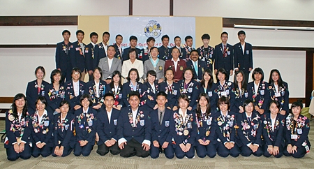 The Rotary Youth Exchange committee poses for a group photo with the outbound students.