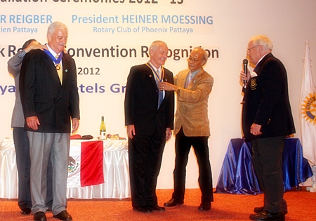 Heiner Moessing (right) receives his presidential medal, while his predecessor, Hubert Maier has his removed. On the far right is Brendan Kelly.