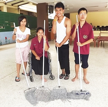 Students and helpers take time out from cleaning to pose for a commemorative photo.