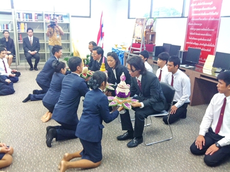 Students representatives present flowers to their teachers as a show of respect during the wai khru ceremony. 