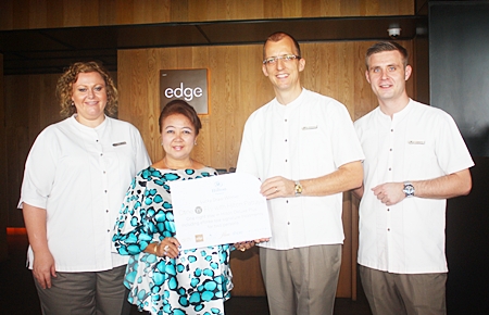 Preeyapat Chomjinda from Chonburi (2nd left), one of the lucky winners of Dine and Fly With Hilton Pattaya, receives her prize from Hilton Pattaya General Manager Harald Feurstein (2nd right).