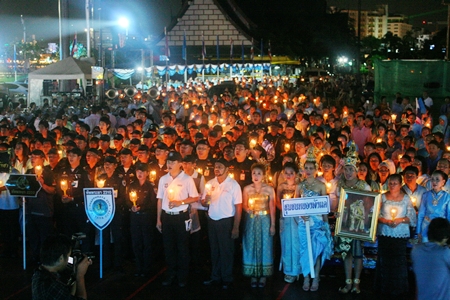Despite the rain, People sing happy birthday and say prayers during the candlelight ceremony at Bali Hai pier.