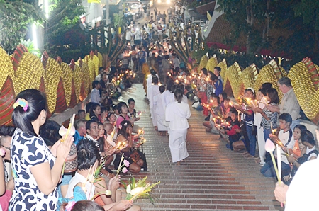Buddhist monks and nuns walk down the stairs to join in candle parade at Wat Phra Yai.