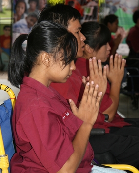 Students of the Father Ray Foundation join the monks in prayer.
