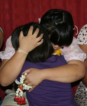 A teacher comforts one of the young girls at the Children’s Home.