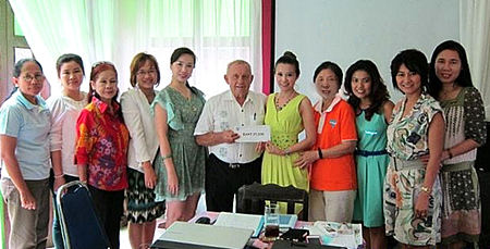 Jesters Care for Kids’ Project Advisor Bernie Tuppin presents Praichit Jetpai, President of Pattaya YWCA, with funds to support this combined project.