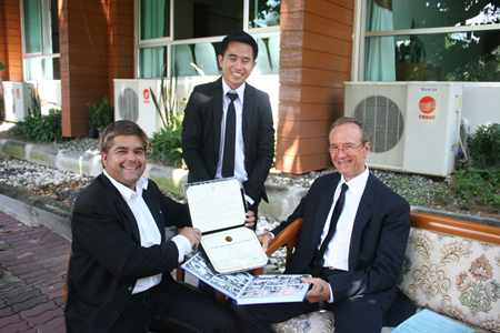 Recent graduate Rienchai shows off his accomplishments to Tony and Woody.