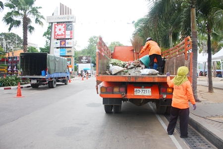 City workers clean up the usual mess left behind by still another big event on Beach Road. 