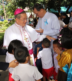 Bishop Emeritus Thienchai Samanjit spreads his loving care amongst the children.