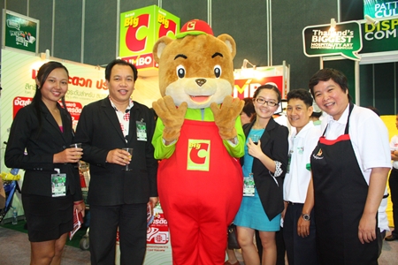 (L to R) Sujittra Roopjan (front office assistant manager), Viroj Srisai (front office manager), Big C Mascot, Panida Amnuayyonwaree (managing director), Udon Yalai (purchasing manager for Aiyara Grand Hotel) and Tipawan Kripechra (project director, Big C Jumbo Station) welcome guests to the Big C Jumbo booth at the Pattaya Food & Hotelier Expo. 