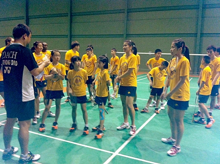 Ratchanok ‘May’ Inthanon, right, helps coach youngsters at the CAT Sports Club in Pattaya, Saturday, August 11. 