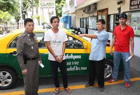 Taxi driver Peera Saeneesot points to Thongchai Khucharoen, the man who stole his taxi. 