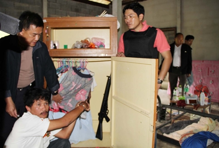 Chirawat Seuasing (bottom) shows police where the gun was hidden. 