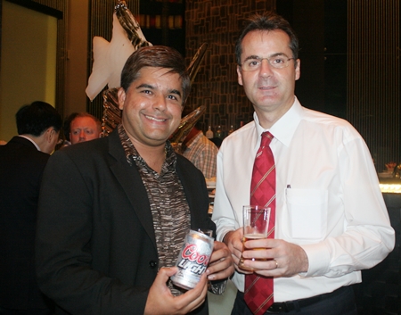 Tony Malhotra (Deputy MD Pattaya Mail) and Richard Margo (RM Amari Orchid Pattaya) discuss the taste of the American Coors Light beer.