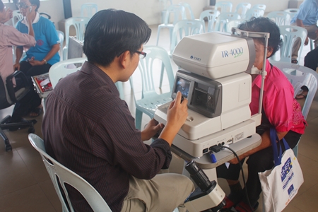 Elderly folks are given a follow-up eye check before being given their glasses. 