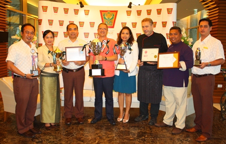 Andre Brulhart (center), general manager of Centara Grand Mirage Beach Resort, congratulates managers of each department for helping the hotel win many awards. 
