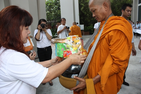 Darika Chaloeithoi, human relations director, leads employees to offer necessities to monks at the Holiday Inn Pattaya.