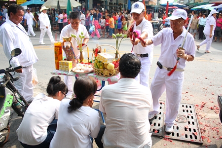 People along the parade route in Naklua receive blessings.
