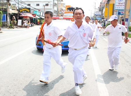 Honored men bring ancient symbols to the people to pay respect.