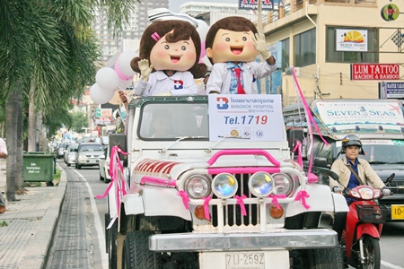 Mascots from Bangkok Hospital Pattaya hitch a ride on the BHP jeep during the parade.