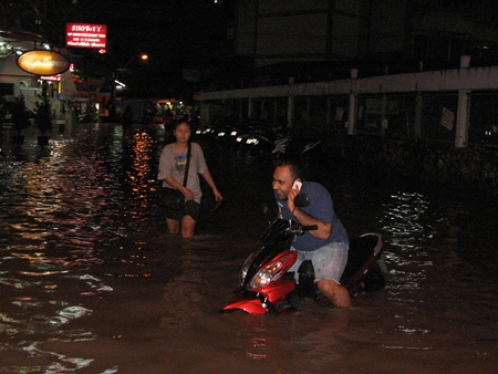 The leading edge of Tropical Storm Gaemi packed a major punch, causing floods throughout Pattaya.  Here, a tourist tries to evacuate his motorcycle from Soi Marine Plaza just off Waling Street late Friday night / early Saturday morning.  But as the entire kingdom battened down the hatches, expecting the worst, the storm lost strength over land and fizzled as it passed overhead. 
