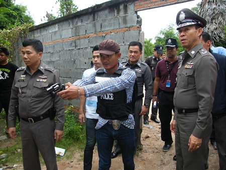 Sahas Butdoi reenacts the murder for police and reporters. 