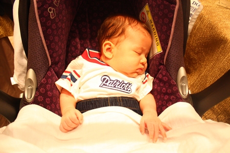 A future Patriots’ fan rests up during the busy proceedings.