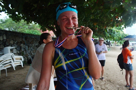Natalia Lunev shows off her medal after winning the 1.2 km swim.