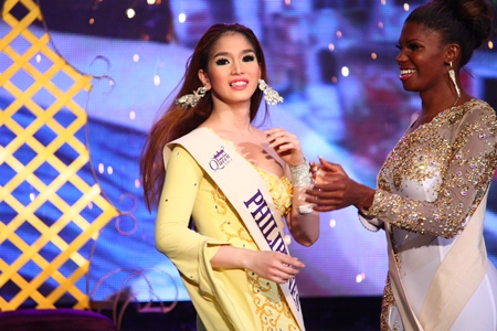 First runner-up Jessika Simoes of Brazil (right) applauds Kevin Balot after the later was announced winner of the Miss International Queen 2012 contest.