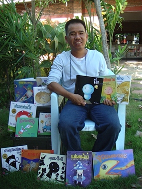 Famous author Cheewan Visasa shows off his collection of children's books.
