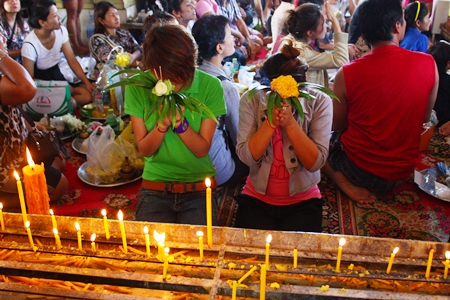 Young worshippers pray at Wat Chaiyamongkol in South Pattaya, marking the end of Buddhist Lent on Tuesday, Oct. 30.  Pattaya area residents joined the rest of the Buddhist world in celebrating Auk Pansaa by going to local temples for merit-making and commemorating Buddha’s descent from heaven via a staircase of crystal, silver and gold. 