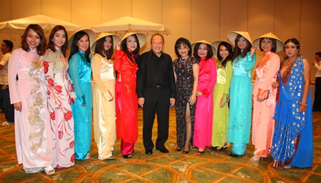 Chatchawal Supachayanont (center) poses with employees dressed in their Vietnam National Costumes.
