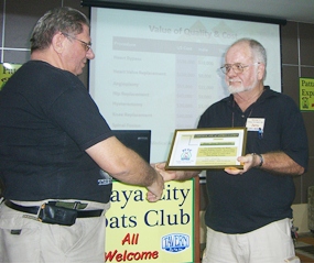 Board member Jerry Dean presents member Jon (Hans) Stroosnyder with a certificate recognising Jon’s services to the club, particularly assisting members with monthly visits to the Motor Registry to get licences and car registrations.