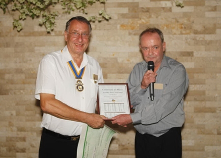 Carl Dyson, President of the Rotary Club Eastern Seaboard (left), is presented with a cheque for 100,000 baht.