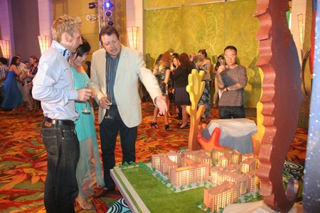 Party-goers view a scale model of the Seven Seas project.