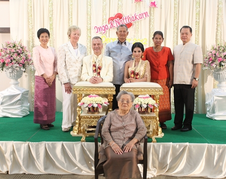 The newlyweds are joined by their respective families for a group photograph.