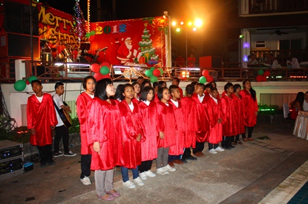 Children from the Father Ray Foundation sing Christmas carols at Diana Inn Hotel.