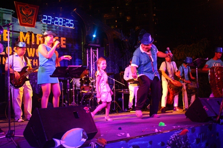A youngster takes to the stage, joining the music performance at Centara Grand Mirage Beach Resort Pattaya.