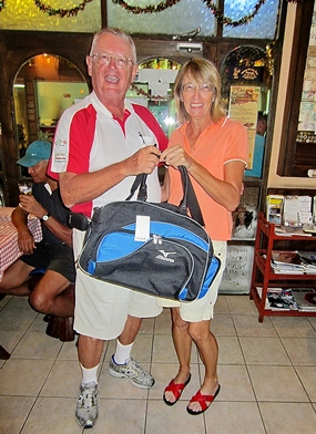 Carole Kubicki (right) is presented with the MBMG Golfer of the Month award by Dick Warberg. 