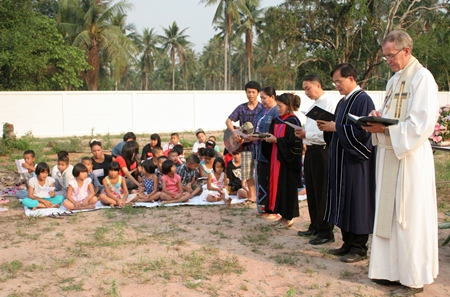 Priests conduct the consecration ceremony as children join in singing hymns.