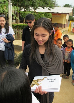 Phantila Phataraprasit donates copies of her book “The Story of Baitong & Boon” to children in Kiew Karn Village.