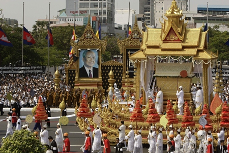 The chariot carrying the casket of Cambodia’s late former King Norodom Sihanouk leads the funeral procession in Phnom Penh, Friday, Feb. 1. Norodom Chakrapong, brother of Cambodian King Norodom Sihamoni, is seen at third right at the chariot.(AP Photo/Heng Sinith)