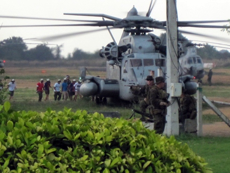 Japanese roll playing evacuees board a U.S. Marine Corps CH-53 helicopter during an Emergency Evacuation Exercise in Pattaya.