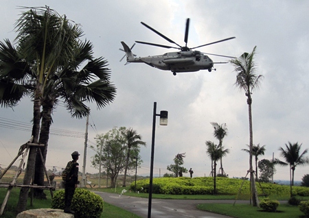 PFC Bret Mays from the Young Marines Pattaya watches a U.S. Marine Corps CH-53 helicopter departing the Evacuation Center’s Landing Zone.