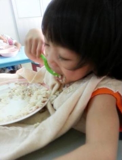 Eating by herself.