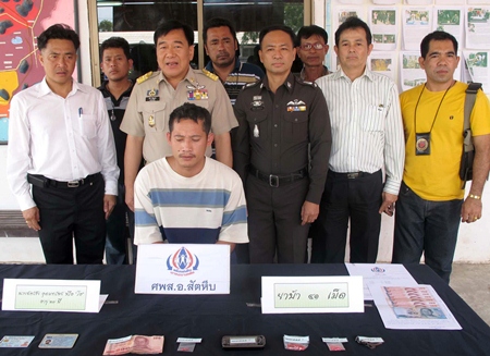 Sattahip and Royal Thai Navy officials captured Chatchai Udomzup (seated) for allegedly selling ya ba.