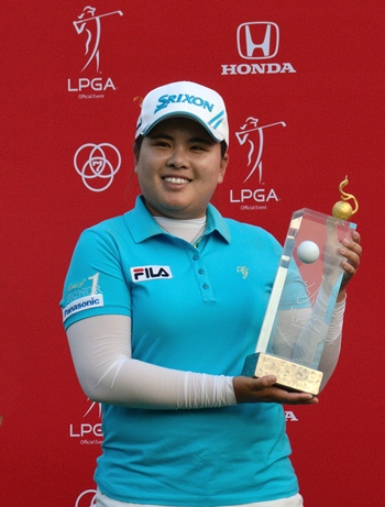 / South Korea’s Inbee Park holds up the champion’s trophy after winning the 2013 Honda LPGA Thailand Championship at Siam Country Club, Pattaya, Sunday, Feb. 24.