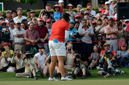 The gallery around the 18th green gasps as Jutanugarn misses a short putt to force a playoff.