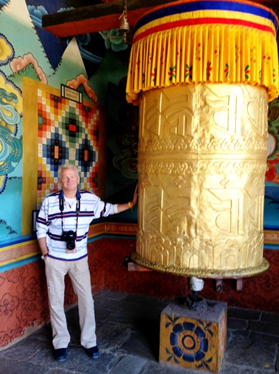 The author dwarfed by a massive prayer wheel at the entrance to the Punakha Dzong - Bhutan.